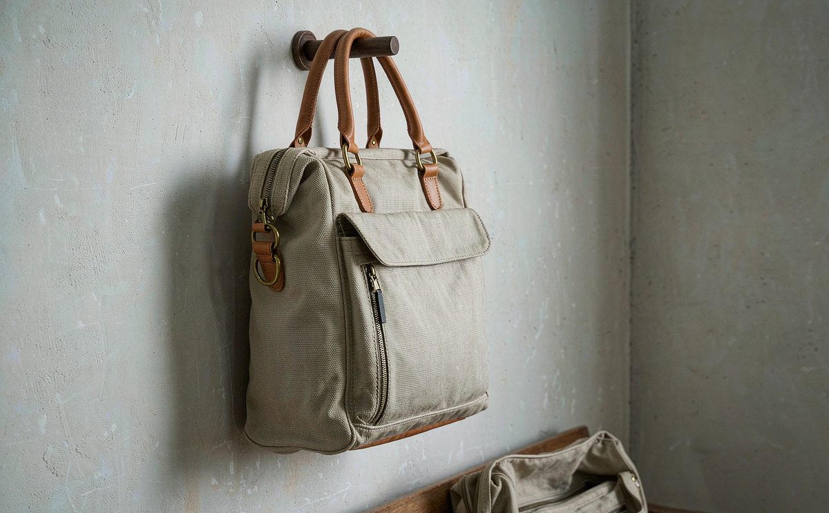 Custom tote bag prototypes in canvas and nylon with gusset bases, webbing handles and printed front panels arranged for sampling review